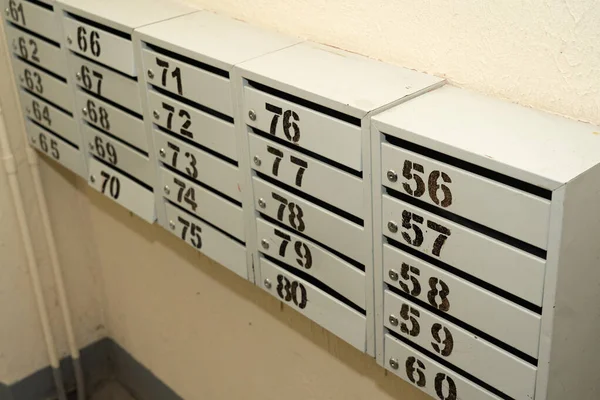 Mailboxes in a residential apartment building. Apartment numbers on mailboxes.