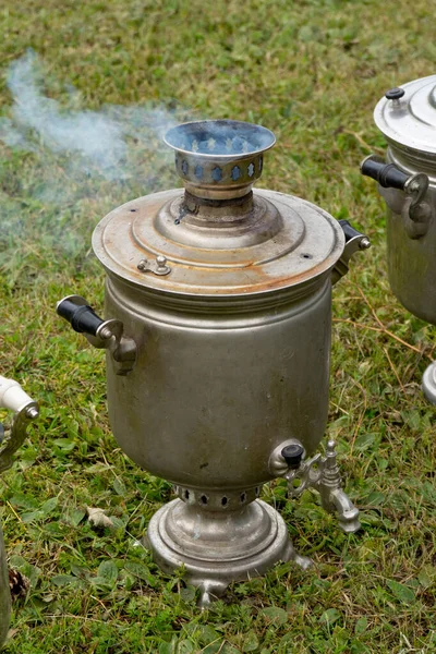 Samovar in a clearing in the process of heating water. Samovar - a traditional Russian obsolete wood kettle