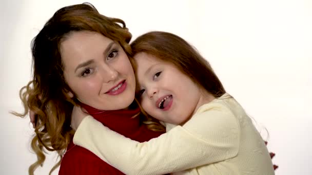 Little Girl Hugs Her Mom Close White Background — Stockvideo