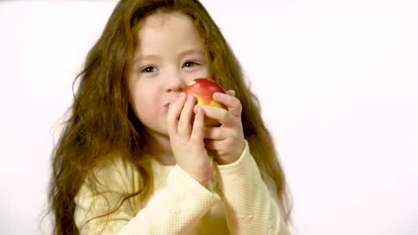 Girl Years Old Long Hair Happily Eats Apple Studio White — Stockvideo