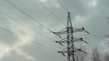 The rapid movement of gray clouds on the background of power lines.