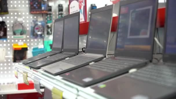 Jekaterynburg, Rosja - luty 2020 r. Laptopy na półkach w sklepie elektronicznym. Stojaki w sklepie komputerowym z różnymi laptopami. — Wideo stockowe