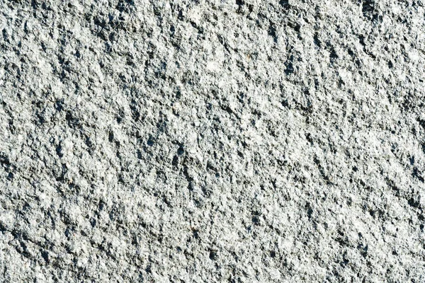 灰色の粗い天然花崗岩の質感 側面照明 — ストック写真