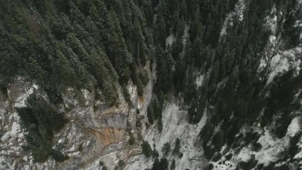 Aerial footage of mountain ranges and cliffs covered with snow — Stock Video