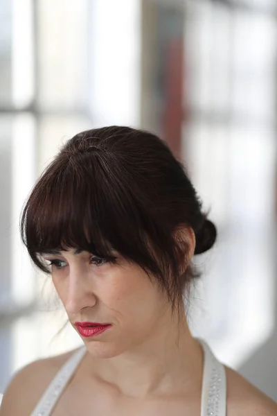 Sad Woman with Brown Hair Eyes at an Art Gallery — Stock Photo, Image