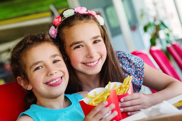 Two happy girls in fast food restaurant — Stock Photo, Image