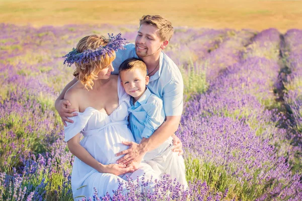 Happy young family outdoors in a lavender field — Stock Photo, Image