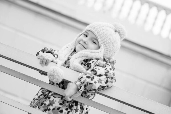 portrait of a little girl near the fence 