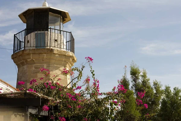 Outdoor architecture of an old lighthouse in Cyprus and cloudy blue sky