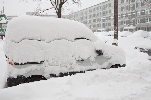 cars on parking lot after snowfall