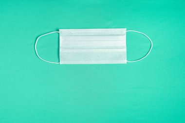 Minimalist yeşil arkaplan üzerinde cerrahi maske