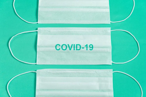 stock image Surgical mask over minimalist green background