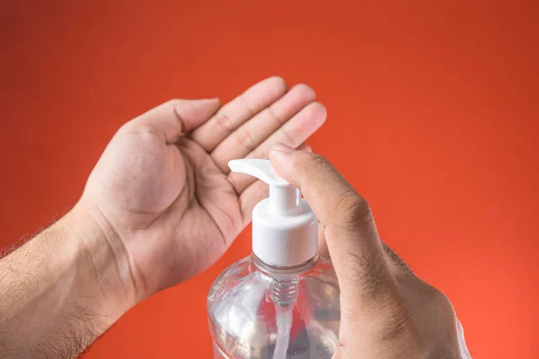 Man Hand Container Alcohol Gel Red Background — Stock Photo, Image