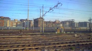 MILAN, ITALY; 03.03.2020: Railway station in the city center. Italian high-speed trains Trenitalia Frecciarossa Italo. Passengers with luggage pass through the station. Covered station. Locomotive. A sign with the inscription Train on the scoreboard