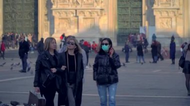 Milan Italy March 3, 2020: people in protective masks. Panic from the Chinese viral corona Covid 19 in Italy. People in the Duomo square and city streets. Quarantine in Milan. Epidemic. Panic MFW. 