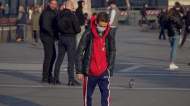Milan Italy March 3, 2020: people in protective masks. Panic from the Chinese viral corona Covid 19 in Italy. People in the Duomo square and city streets. Quarantine in Milan. Epidemic. Panic MFW. 
