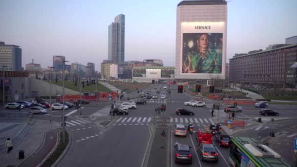 Milan Italy march 6, 2020: City traffic in Milans new business district. Traffic light. Cars in the city. Evening streets of the ancient city in Lombardy. The architecture of Italian architects.