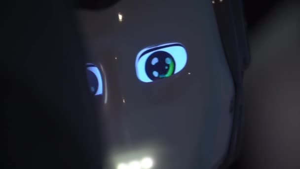 机器人表现出情感 人工智能 现代机器人 机器人看着人 对人笑 机器人的眼睛 机械人 机器人正看着摄像机盯着一个人 智能计算机 给孩子们的好玩具 — 图库视频影像