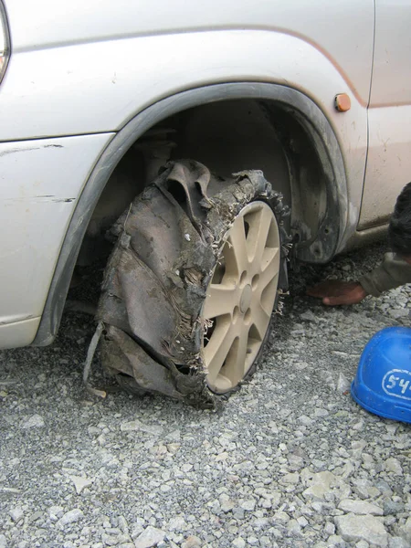 Pierced wheel traveled on crushed stone. Car wheel is broken, flat tire, drove a few minutes on a broken wheel result