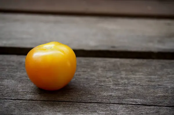 Hele tomaten op een houten bord — Stockfoto