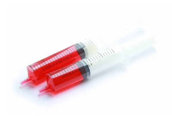 Syringe with red liquid isolated on white background — Stock Photo, Image