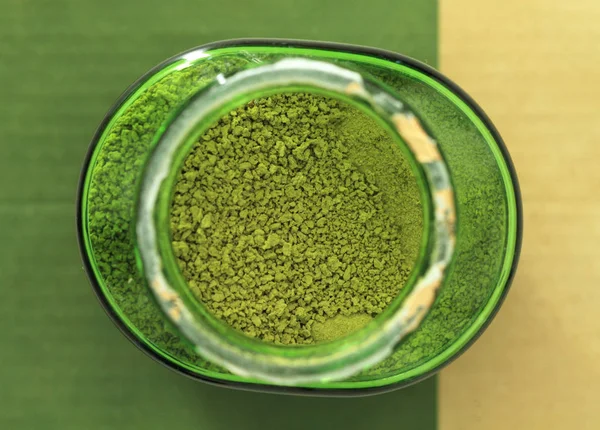 Top view of green tea powder in bottle
