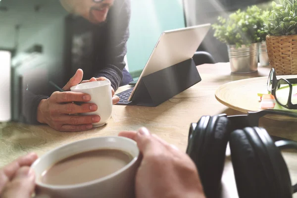 co working website designers working at office and holding a cup