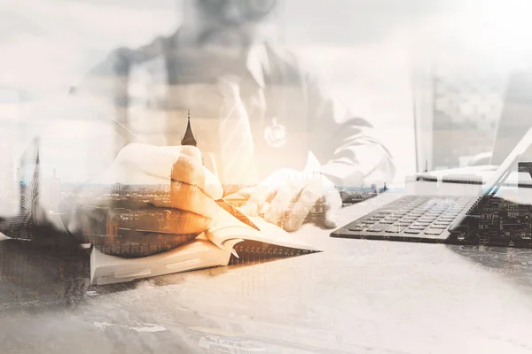 Medical doctor writing on notebook and digital tablet docking ke — Stock Photo, Image