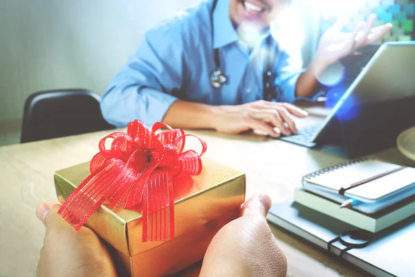 Gift Giving.Patient hand or Team giving a gift to a surprised Me