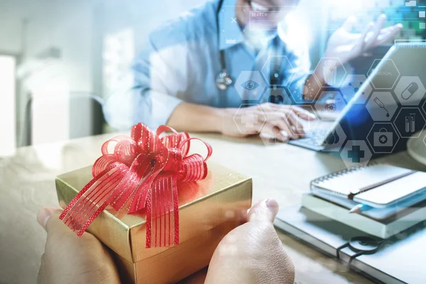 Gift Giving.Patient hand or Team giving a gift to a surprised Me — Stok Gambar Gift Giving.Patient hand or Team giving a gift to a surprised Me Stok Lukisan