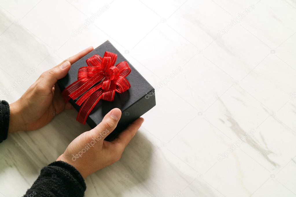 gift giving,man hand holding a gift box in a gesture of giving o
