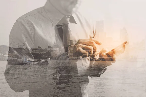 Double exposure of success businessman using smart phone with Lo — Stock Photo, Image