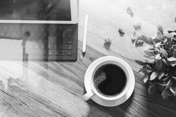 Koffiekopje en digitale tabel dock slimme toetsenbord, vaas bloem haar — Stockfoto