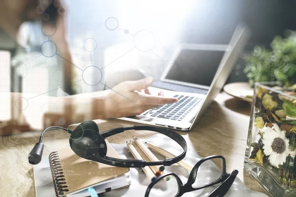 Man using VOIP headset with digital tablet computer docking smar