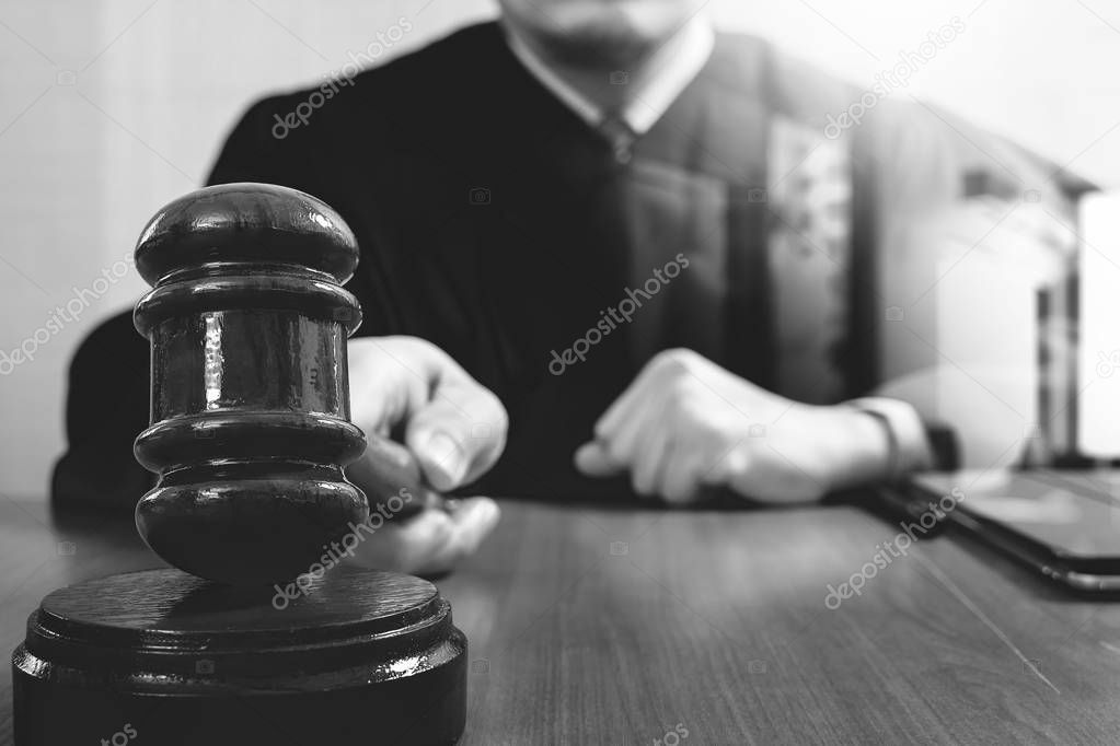 justice and law concept.Male judge in a courtroom striking the g
