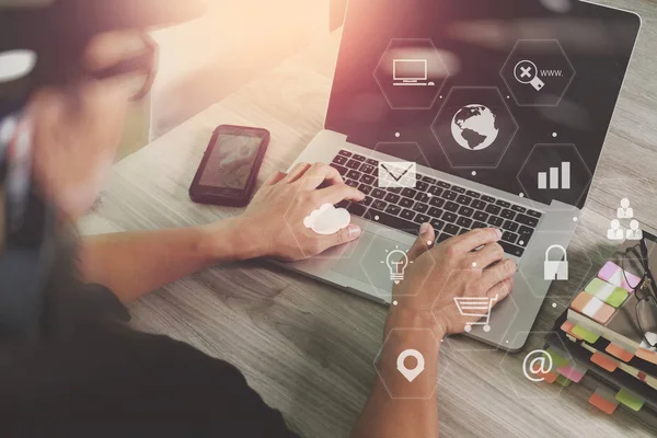 Businessman working with smart phone and laptop computer on wood — Stock Photo, Image