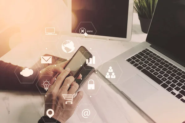 Businessman working with smart phone and laptop computer on wood — Stock Photo, Image