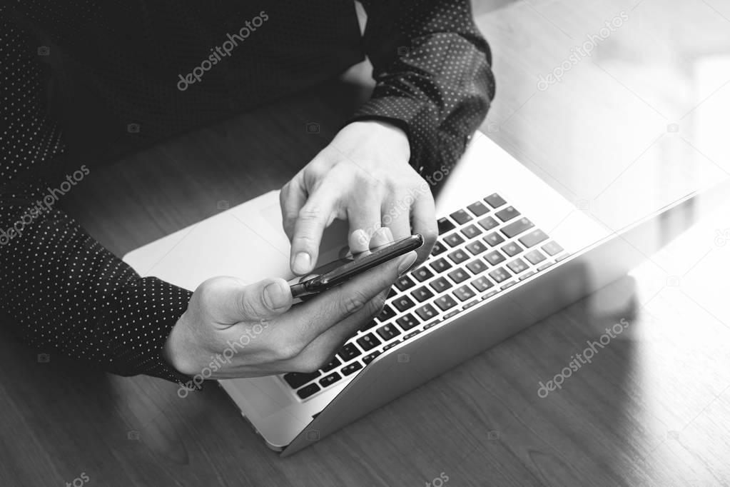 top view,business man hand using smart phone,laptop, online bank