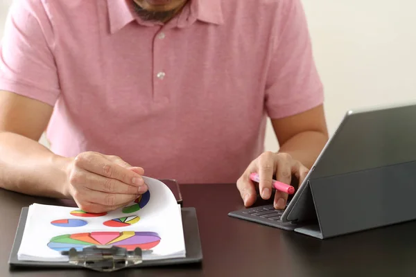 Pengusaha dalam t-shirt pink bekerja dengan komputer tablet digitl — Stok Foto