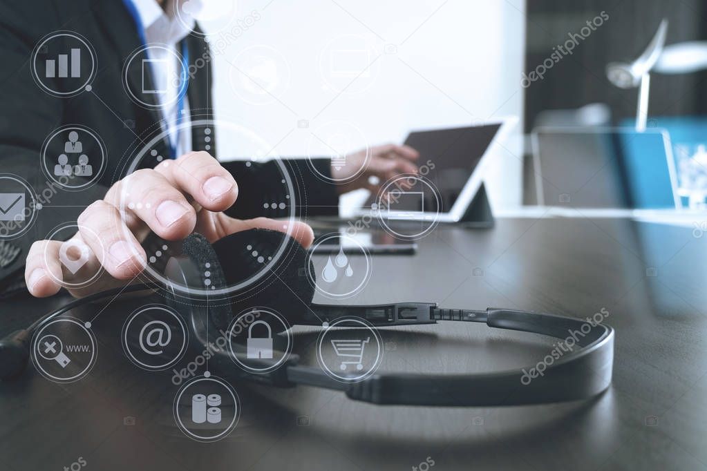Man using VOIP headset with digital tablet and laptop computer a