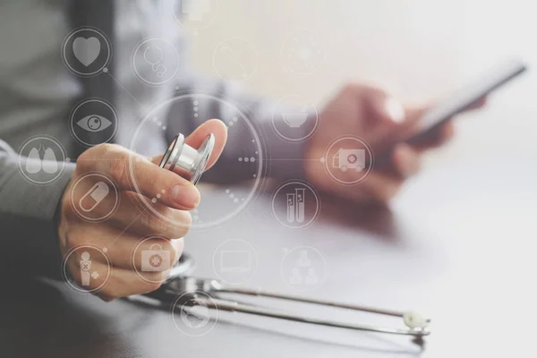 Close up of smart medical doctor working with stethoscope and mo — Stock Photo, Image