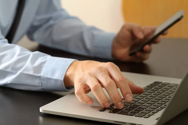 Close up of businessman working with mobile phone and laptop com — Stock Photo, Image