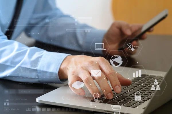 Close up of businessman working with mobile phone and laptop com — Stock Photo, Image