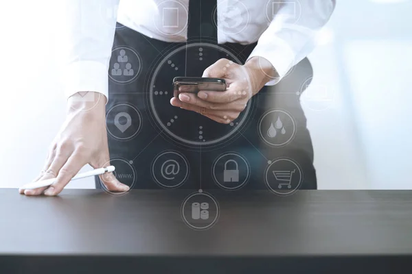 Close up of businessman working with smart phone on wooden desk — Stock Photo, Image