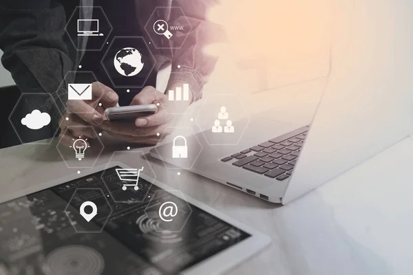 Businessman working with smart phone and laptop computer on wood — Stock Photo, Image