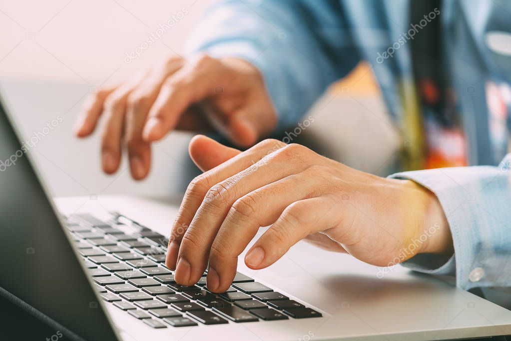 close up of businessman typing keyboard with laptop computer on 