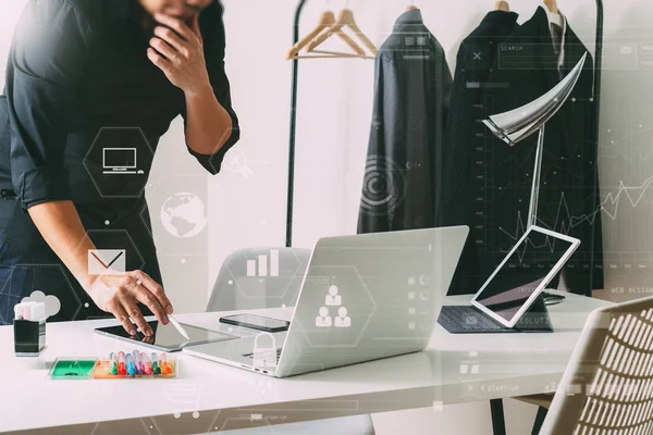 Modedesigner prata mobiltelefon och använda laptop med digi — Stockfoto