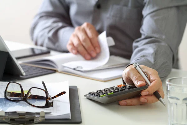 Businessman hand working with finances about cost and calculator — Stock Photo, Image