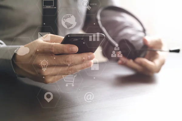 Businessman using VOIP headset with mobile phone and concept com — Stock Photo, Image