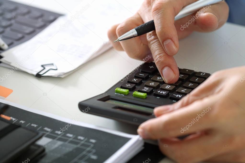 close up of businessman hand working with finances about cost an